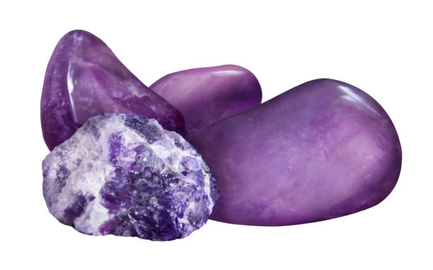 Tumbled and raw Amethyst crystals, varying shapes and textures.