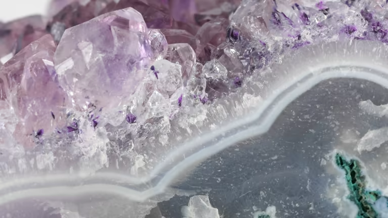 Close-up of a delicate Amethyst crystal geode slice with banded agate layers.