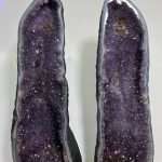 Museum-quality 121 lb matching Uruguayan amethyst twin towers known as the Twin Guardian Towers, featuring deep velvet purple crystals on custom carved wood stands