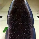 Museum-quality 17.6 lb amethyst flame geode known as the Imperial Midnight, featuring ultra-dark black amethyst crystals and a triple-curved polished agate rim