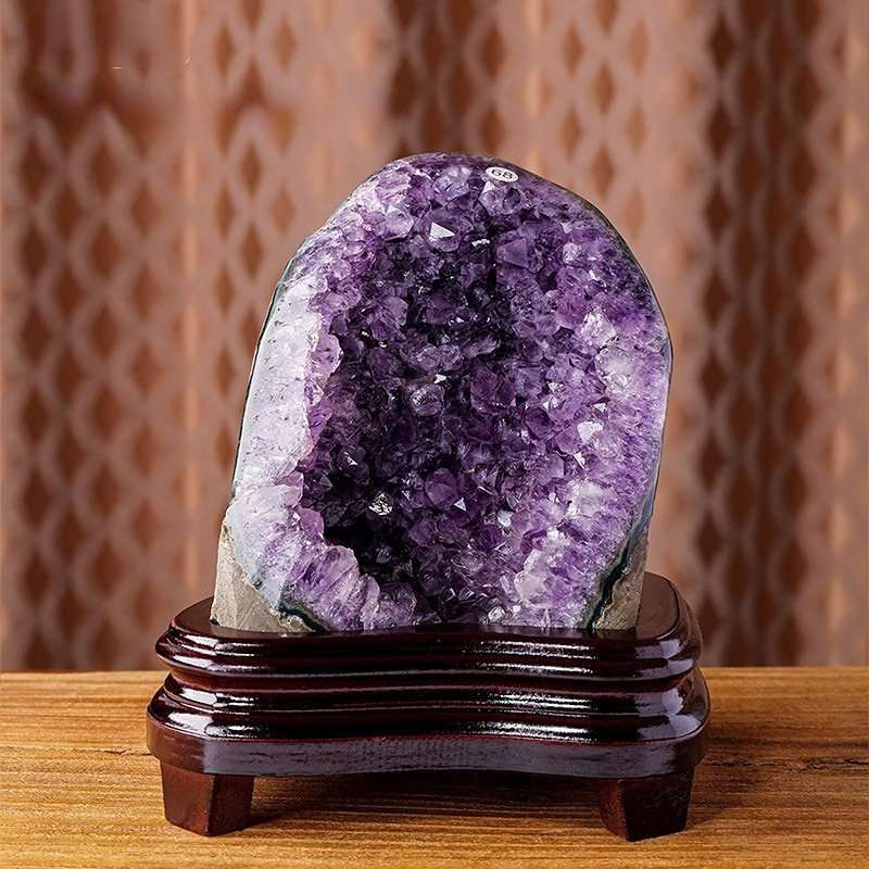 One-of-a-kind rounded deep purple amethyst cave with thick agate banding resting on a custom wood stand, specimen number 2