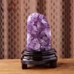 One-of-a-kind deep purple amethyst cave with a wide crescent smiling shape and prominent white agate banding on a custom wood stand, specimen number 7