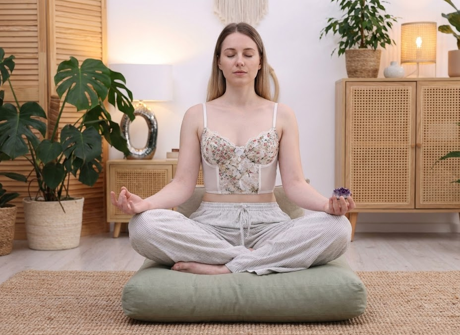 Woman meditating with amethyst crystal for stress relief and spiritual healing