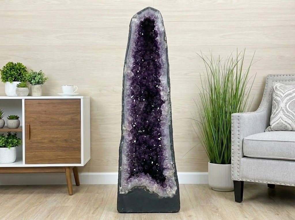 Large amethyst geode placed in a modern living room for Feng Shui wealth corner