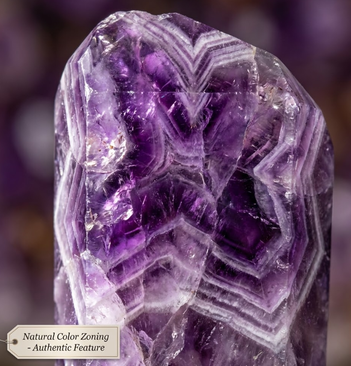Close-up of amethyst crystal with striking natural chevron color zoning and authentic patterns.