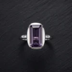 Classic Amethyst Solitaire Ring featuring a brilliant-cut natural purple gemstone in a vintage-textured 925 sterling silver adjustable setting.