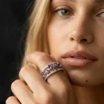 High-fashion model close-up wearing the Luxury Amethyst and Sapphire Ring, demonstrating its elegant designer appeal and artistic presence as a statement piece.