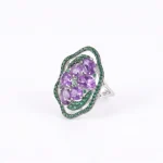 The Grand Sovereign Heirloom Amethyst Ring in 925 silver, showcasing the massive AAA natural amethyst cluster and vibrant green halo.