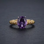 Modernist Amethyst Ring featuring a natural oval crystal elevated in a high-prong 925 sterling silver adjustable setting.