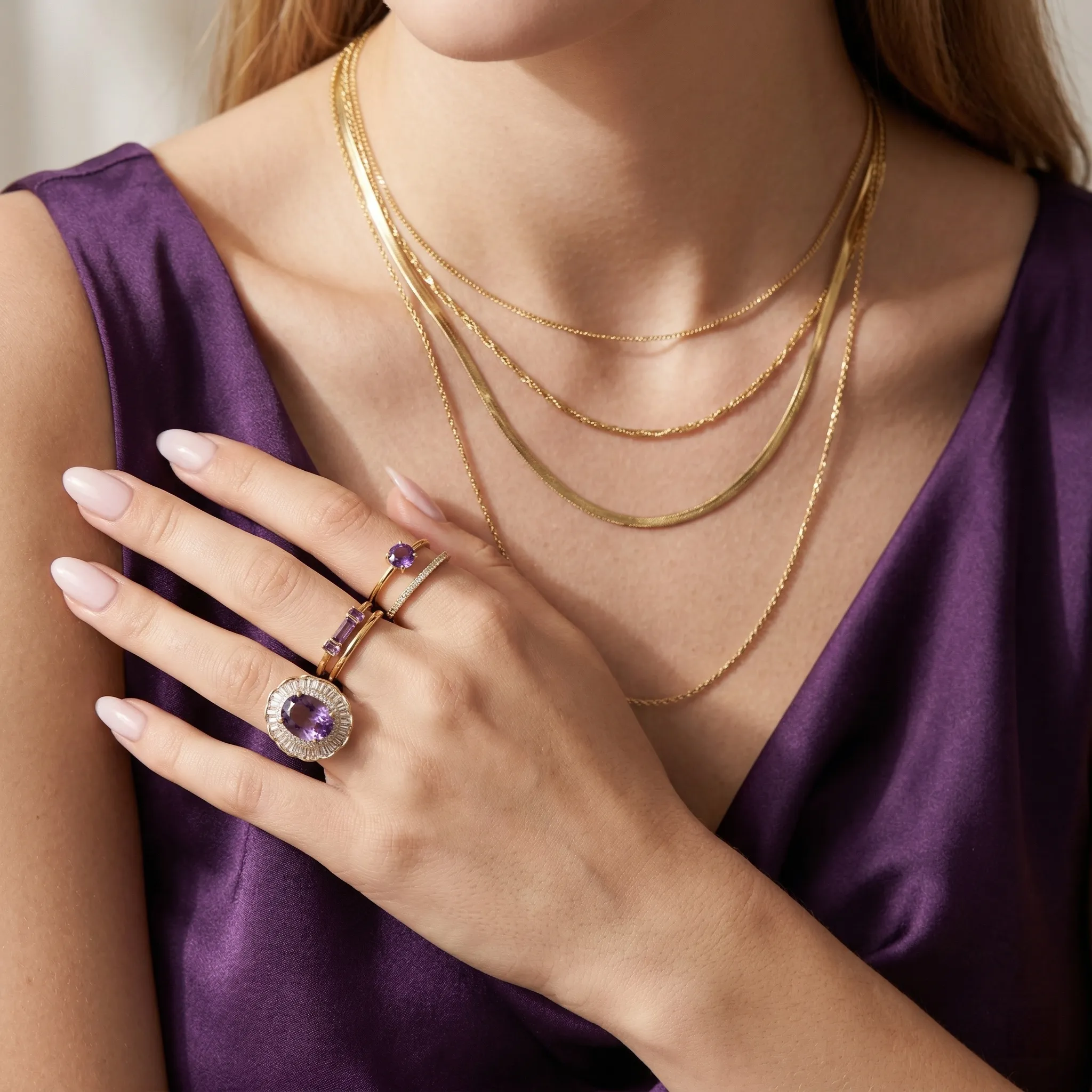 Model wearing The Empress High-End Amethyst Ring on a dark velvet background, demonstrating its powerful royal statement and substantial scale on hand.