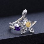 Macro close-up of the Lotus Amethyst Ring, focusing on the gold-plated stamen details and the deep violet fire of the natural crystal.